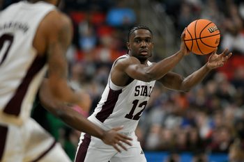 Mar 21, 2025; Raleigh, NC, USA; Mississippi State Bulldogs guard Josh Hubbard (12) passes the ball against the Baylor Bears during the first half in the first round of the NCAA Tournament at Lenovo Center. Mandatory Credit: Zachary Taft-Imagn Images