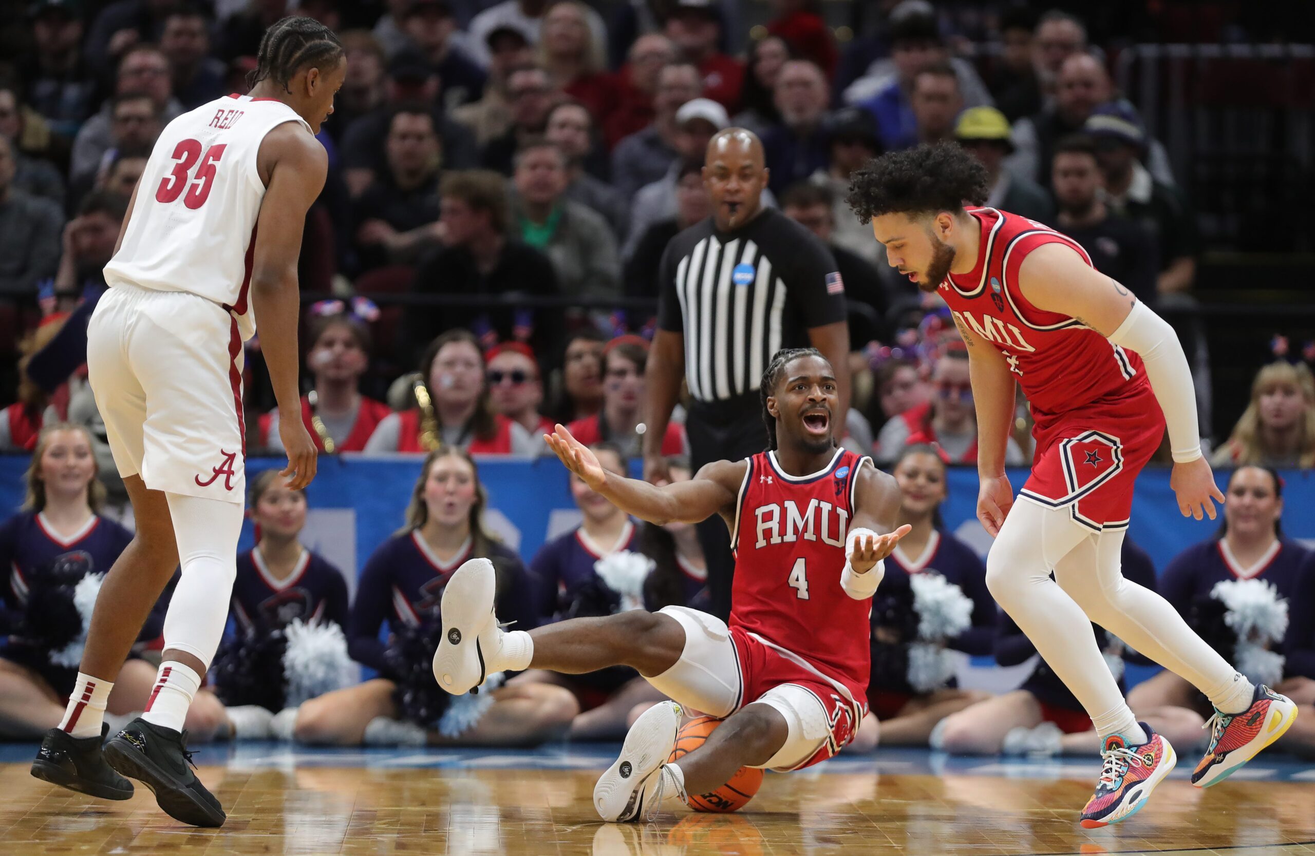 Robert Morris Colonials guard Josh Omojafo (4) reacts after fouling Alabama Crimson Tide forward Derrion Reid (35) during the first half of an NCAA Tournament First Round game at Rocket Arena on Friday, March 21, 2025, in Cleveland, Ohio.