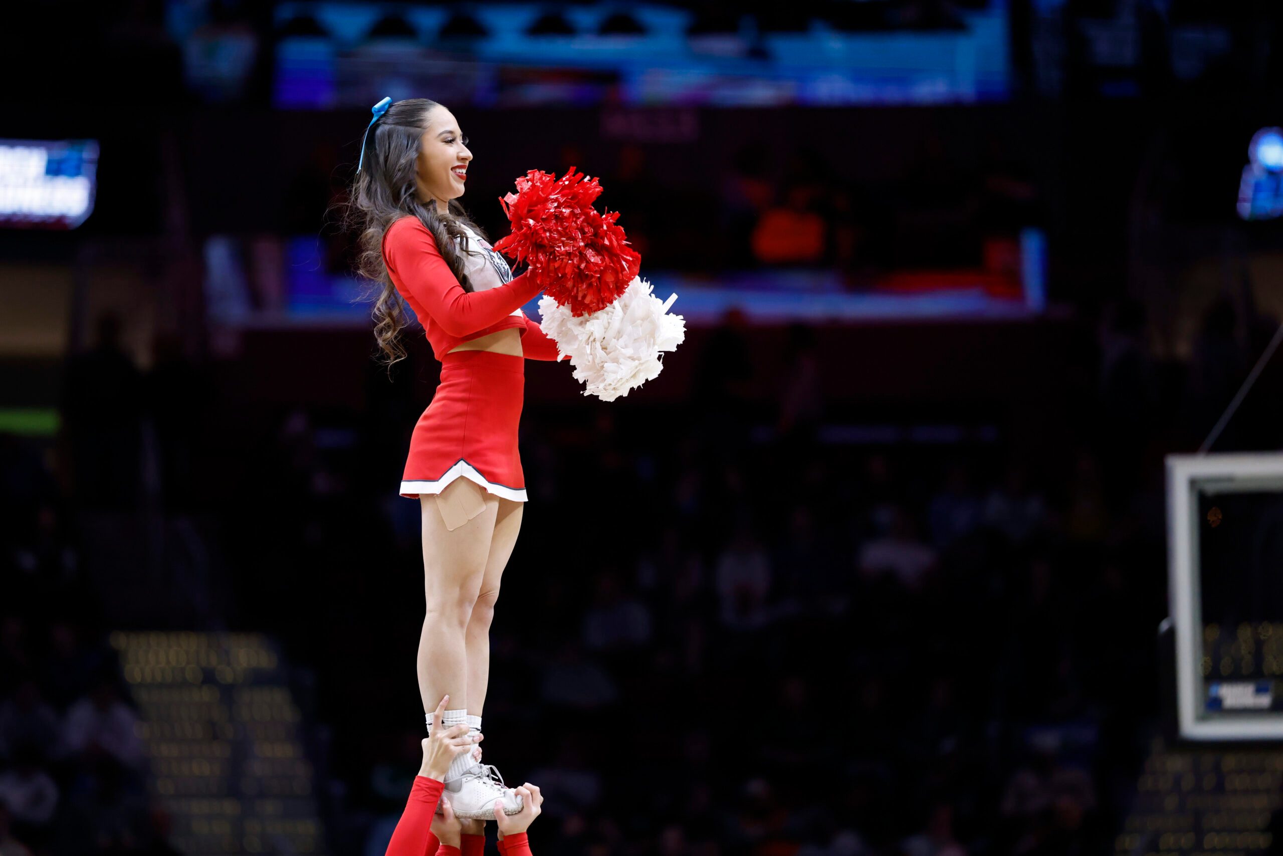 Mar 21, 2025; Cleveland, OH, USA; New Mexico Lobos cheerleader performs in the first half against the Marquette Golden Eagles during the NCAA Tournament First Round at Rocket Arena. Mandatory Credit: Rick Osentoski-Imagn Images