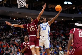 Mar 21, 2025; Milwaukee, WI, USA; Kentucky Wildcats guard Otega Oweh (00) drives to the hoop past Troy Trojans forward Jackson Fields (15) during the second half at Fiserv Forum. Mandatory Credit: Jeff Hanisch-Imagn Images