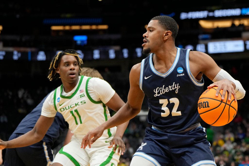 Mar 21, 2025; Seattle, WA, USA; Liberty Flames guard Jayvon Maughmer (32) dribbles the ball against the Oregon Ducks during the second half in the first round of the NCAA Tournament at Climate Pledge Arena. Mandatory Credit: Stephen Brashear-Imagn Images