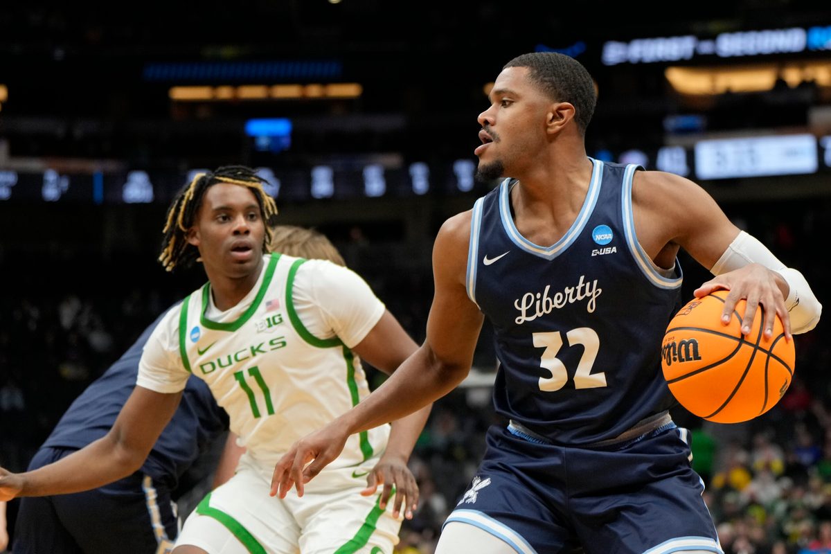 Mar 21, 2025; Seattle, WA, USA; Liberty Flames guard Jayvon Maughmer (32) dribbles the ball against the Oregon Ducks during the second half in the first round of the NCAA Tournament at Climate Pledge Arena. Mandatory Credit: Stephen Brashear-Imagn Images