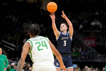 Mar 21, 2025; Seattle, WA, USA; Liberty Flames guard Kaden Metheny (3) shoots the ball against Oregon Ducks guard Jamari Phillips (24) during the second half in the first round of the NCAA Tournament  at Climate Pledge Arena. Mandatory Credit: Stephen Brashear-Imagn Images