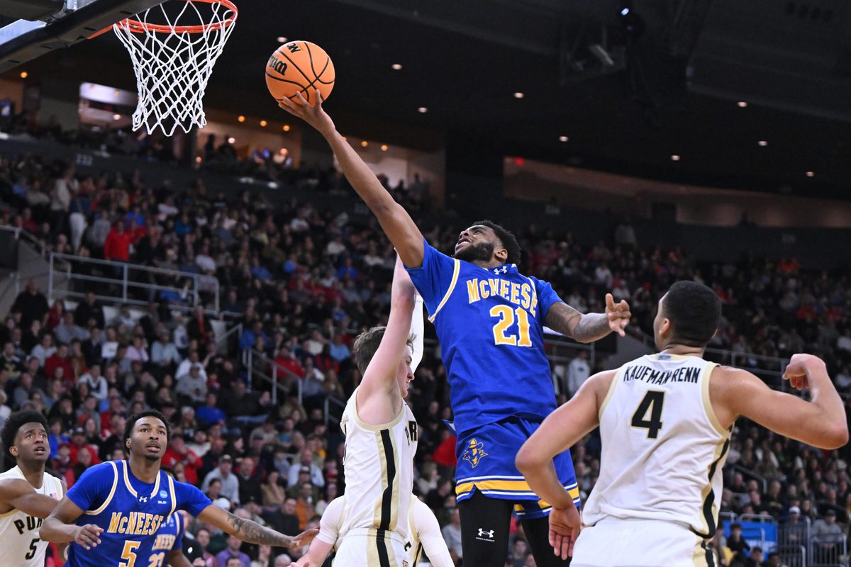 Mar 22, 2025; Providence, RI, USA; McNeese State Cowboys guard Sincere Parker (21) shoots against Purdue Boilermakers guard Fletcher Loyer (2) and forward Trey Kaufman-Renn (4) during the second half of a second round men’s NCAA Tournament game at Amica Mutual Pavilion. Mandatory Credit: Brian Fluharty-Imagn Images