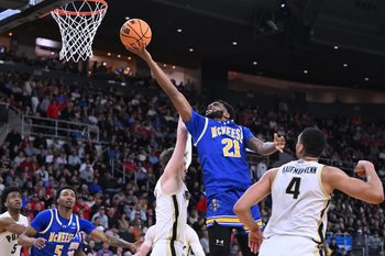 Mar 22, 2025; Providence, RI, USA; McNeese State Cowboys guard Sincere Parker (21) shoots against Purdue Boilermakers guard Fletcher Loyer (2) and forward Trey Kaufman-Renn (4) during the second half of a second round men’s NCAA Tournament game at Amica Mutual Pavilion. Mandatory Credit: Brian Fluharty-Imagn Images