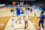 Mar 22, 2025; Wichita, KS, USA; Drake Bulldogs guard Bennett Stirtz (14) shoots the ball against Texas Tech Red Raiders guard Elijah Hawkins (3) and forward JT Toppin (15) during the second half at Intrust Bank Arena. Mandatory Credit: Kirby Lee-Imagn Images