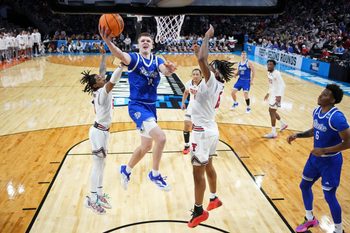 Mar 22, 2025; Wichita, KS, USA; Drake Bulldogs guard Bennett Stirtz (14) shoots the ball against Texas Tech Red Raiders guard Elijah Hawkins (3) and forward JT Toppin (15) during the second half at Intrust Bank Arena. Mandatory Credit: Kirby Lee-Imagn Images