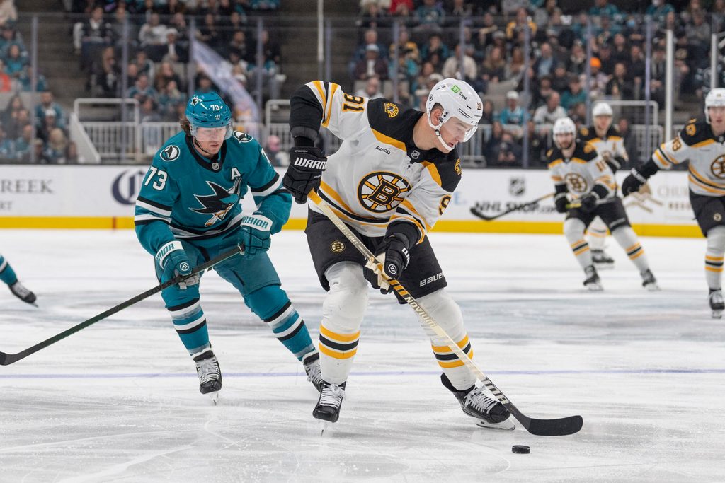 Mar 22, 2025; San Jose, California, USA; Boston Bruins defenseman Nikita Zadorov (91) controls the puck during the second period against San Jose Sharks center Tyler Toffoli (73) at SAP Center at San Jose. Mandatory Credit: Stan Szeto-Imagn Images