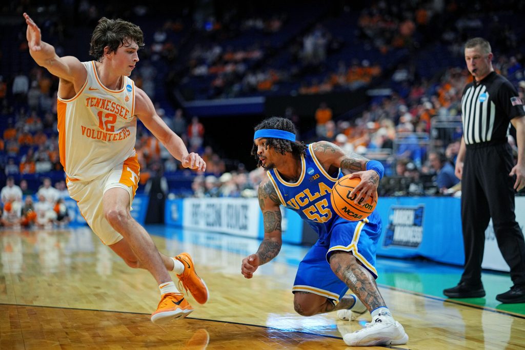 Mar 22, 2025; Lexington, KY, USA; UCLA Bruins guard Skyy Clark (55) handles the ball against Tennessee Volunteers forward Cade Phillips (12) during the second half in the second round of the NCAA Tournament at Rupp Arena. Mandatory Credit: Aaron Doster-Imagn Images
