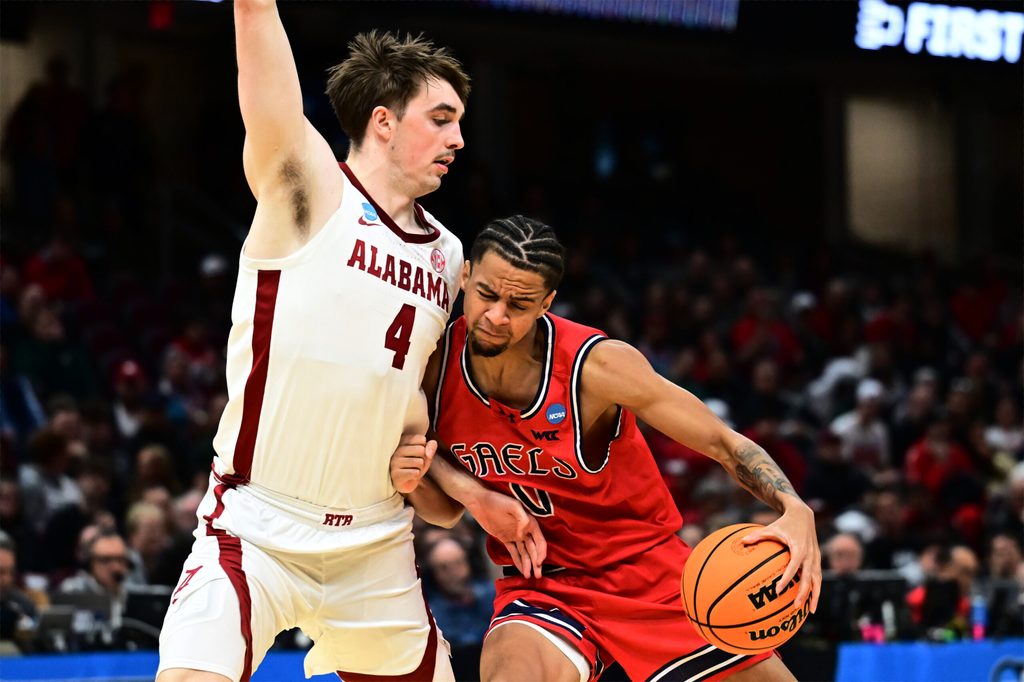 Mar 23, 2025; Cleveland, OH, USA; St. Mary's Gaels guard Mikey Lewis (0) plays the ball defended by Alabama Crimson Tide forward Grant Nelson (4) in the second half during the NCAA Tournament Second Round at Rocket Arena. Mandatory Credit: Ken Blaze-Imagn Images