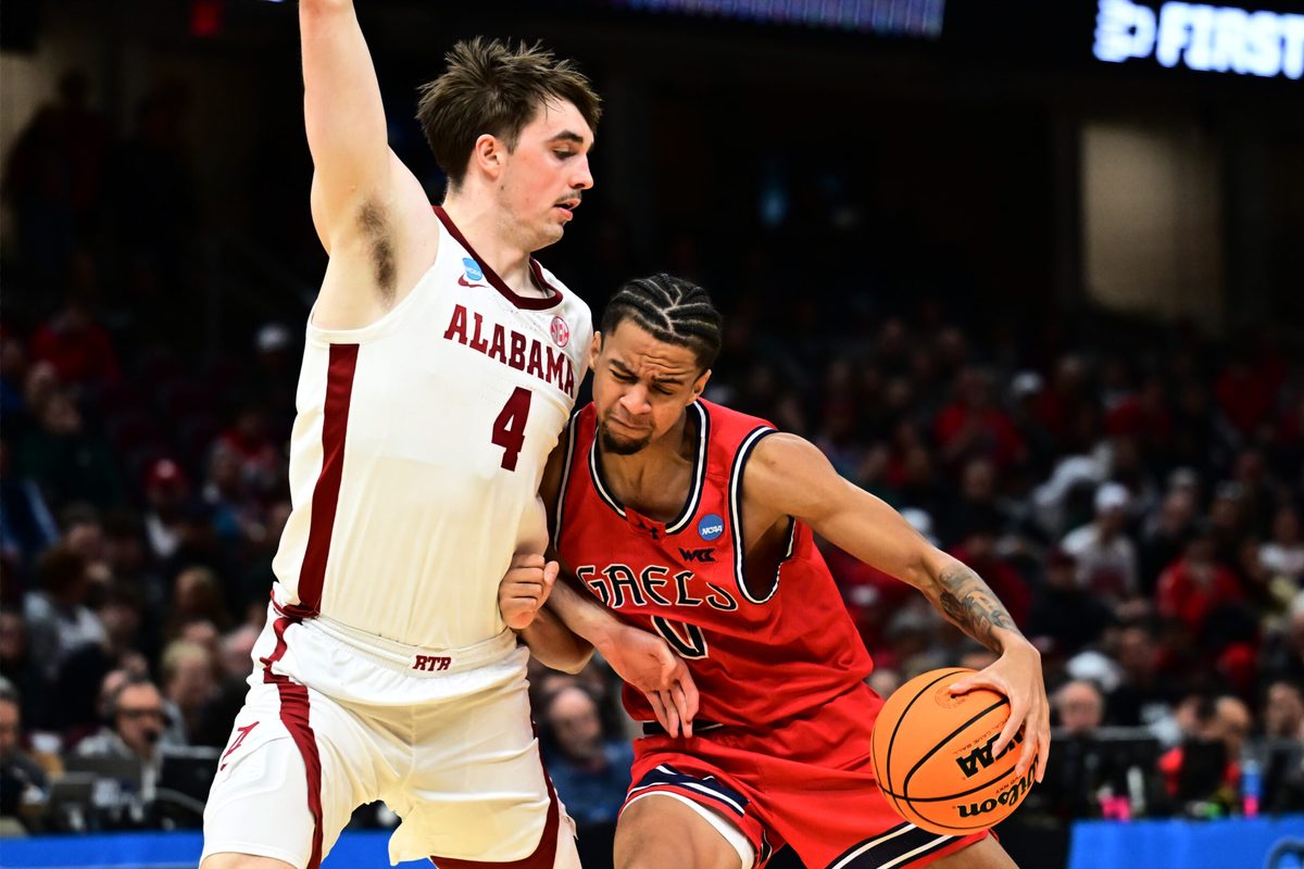 Mar 23, 2025; Cleveland, OH, USA; St. Mary's Gaels guard Mikey Lewis (0) plays the ball defended by Alabama Crimson Tide forward Grant Nelson (4) in the second half during the NCAA Tournament Second Round at Rocket Arena. Mandatory Credit: Ken Blaze-Imagn Images