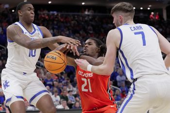 Illinois forward Morez Johnson Jr. (21) is foule day Kentucky forward Andrew Carr (7) and forward Brandon Garrison (10) also defends during the second half of their second round NCAA men’ s basketball tournament game Sunday, March 23, 2025 at Fiserv Forum in Milwaukee, Wisconsin. Kentucky beat Illinois 84-75.