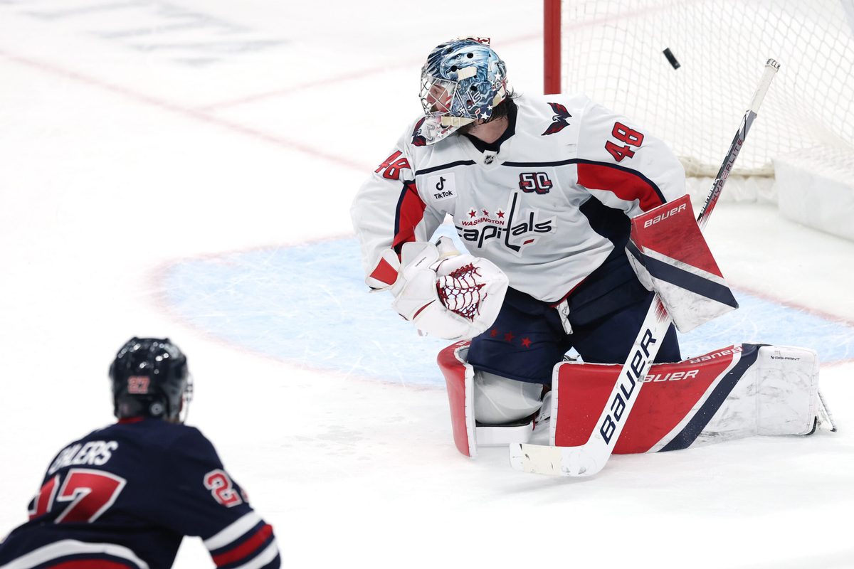 Mar 25, 2025; Winnipeg, Manitoba, CAN; Winnipeg Jets left wing Nikolaj Ehlers (27) scores on Washington Capitals goaltender Logan Thompson (48) in overtime at Canada Life Centre. Mandatory Credit: James Carey Lauder-Imagn Images