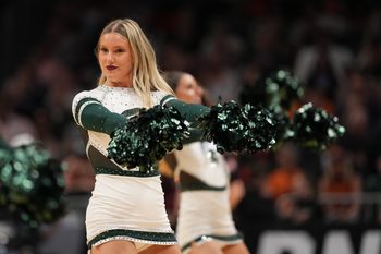 Mar 28, 2025; Atlanta, GA, USA; Michigan State Spartans cheerleaders in the second half of a South Regional semifinal of the 2025 NCAA tournament against the Mississippi Rebels at State Farm Arena. Mandatory Credit: Dale Zanine-Imagn Images