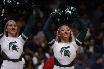 Mar 28, 2025; Atlanta, GA, USA; Michigan State Spartans cheerleaders celebrate after defeating the Mississippi Rebels in a South Regional semifinal of the 2025 NCAA tournament at State Farm Arena. Mandatory Credit: Brett Davis-Imagn Images