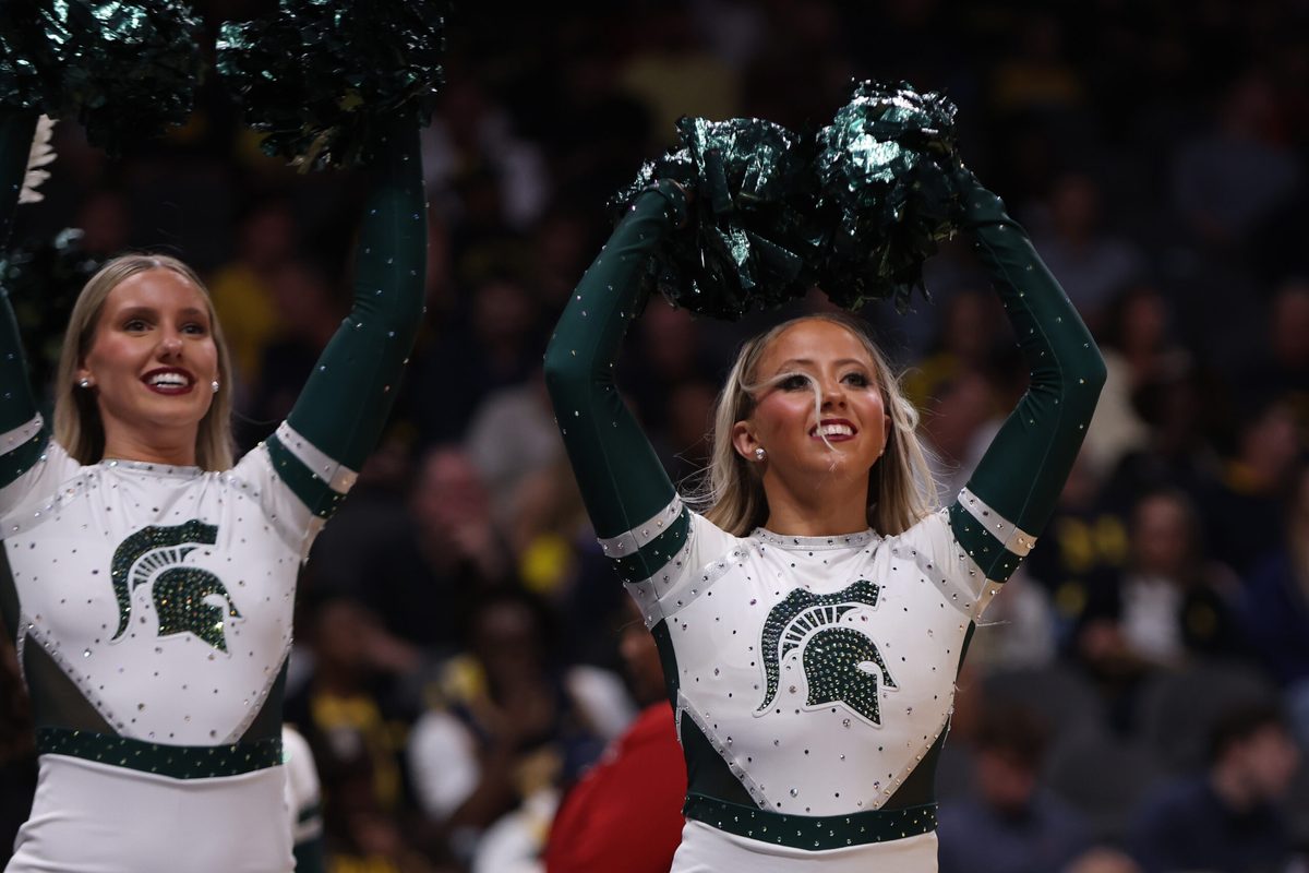Mar 28, 2025; Atlanta, GA, USA; Michigan State Spartans cheerleaders celebrate after defeating the Mississippi Rebels in a South Regional semifinal of the 2025 NCAA tournament at State Farm Arena. Mandatory Credit: Brett Davis-Imagn Images
