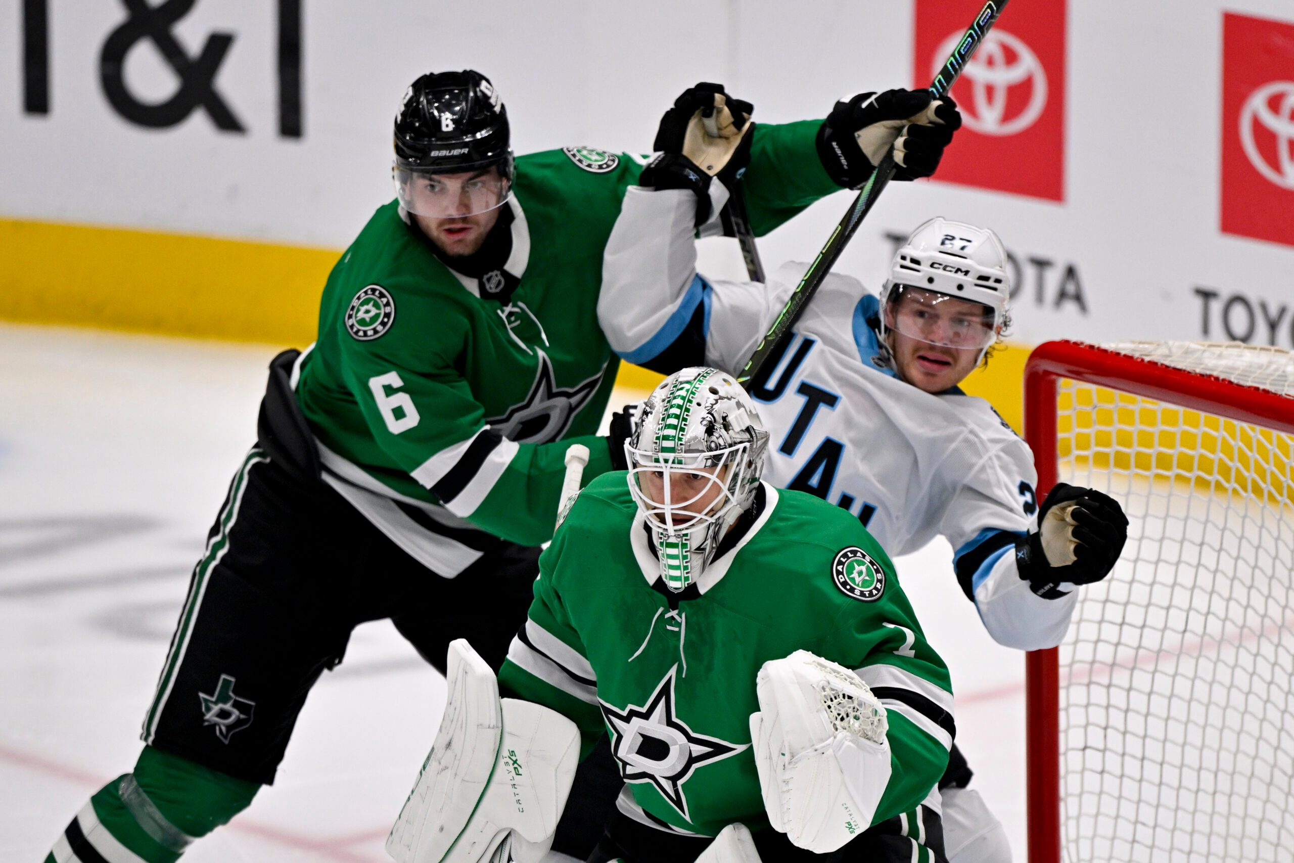 Apr 12, 2025; Dallas, Texas, USA; Dallas Stars defenseman Lian Bichsel (6) checks Utah Hockey Club center Barrett Hayton (27) behind goaltender Casey DeSmith (1) during the third period at the American Airlines Center. Mandatory Credit: Jerome Miron-Imagn Images