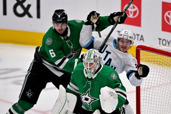 Apr 12, 2025; Dallas, Texas, USA; Dallas Stars defenseman Lian Bichsel (6) checks Utah Hockey Club center Barrett Hayton (27) behind goaltender Casey DeSmith (1) during the third period at the American Airlines Center. Mandatory Credit: Jerome Miron-Imagn Images