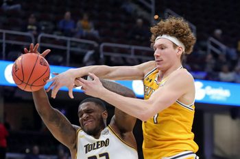 Kent State Golden Flashes forward Magnus Entenmann (14) and Toledo Rockets guard Tyler Cochran (23) fight for a rebound during the second half of an NCAA college basketball game in the quarterfinals of the Mid-American Conference Tournament at Rocket Mortgage FieldHouse, Thursday, March 14, 2024, in Cleveland, Ohio.