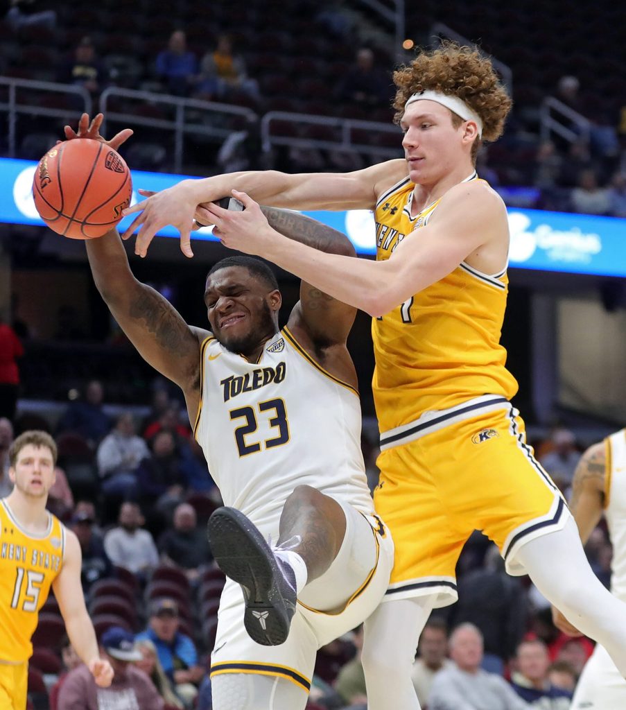 Kent State Golden Flashes forward Magnus Entenmann (14) and Toledo Rockets guard Tyler Cochran (23) fight for a rebound during the second half of an NCAA college basketball game in the quarterfinals of the Mid-American Conference Tournament at Rocket Mortgage FieldHouse, Thursday, March 14, 2024, in Cleveland, Ohio.