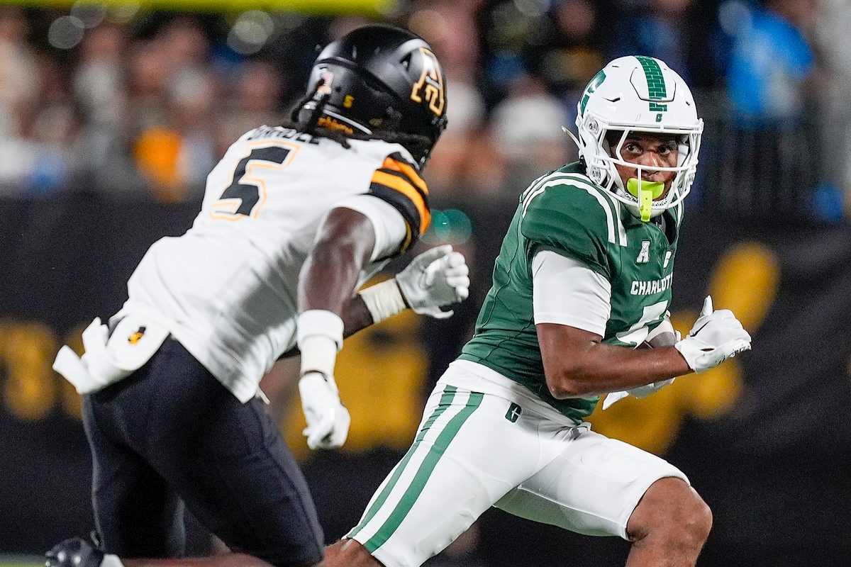 Aug 29, 2025; Charlotte, North Carolina, USA;  Charlotte 49ers wide receiver Javen Nicholas (5) runs for yards after catch defended by Appalachian State Mountaineers defensive back Zyeir Gamble (5) during the second half at Bank of America Stadium. Mandatory Credit: Jim Dedmon-Imagn Images