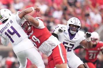 Louisville Cardinals defensive lineman Jordan Guerad (99) pressures James Madison Dukes quarterback Alonza Barnett III (14) in the first half Friday September 5, 2025 at L&N Federal Credit Union Stadium in Louisville, Kentucky.