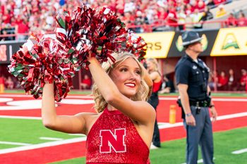 Sep 6, 2025; Lincoln, Nebraska, USA; A Nebraska Cornhuskers cheerleader cheers during the first quarter against the Akron Zips at Memorial Stadium. Mandatory Credit: Dylan Widger-Imagn Images