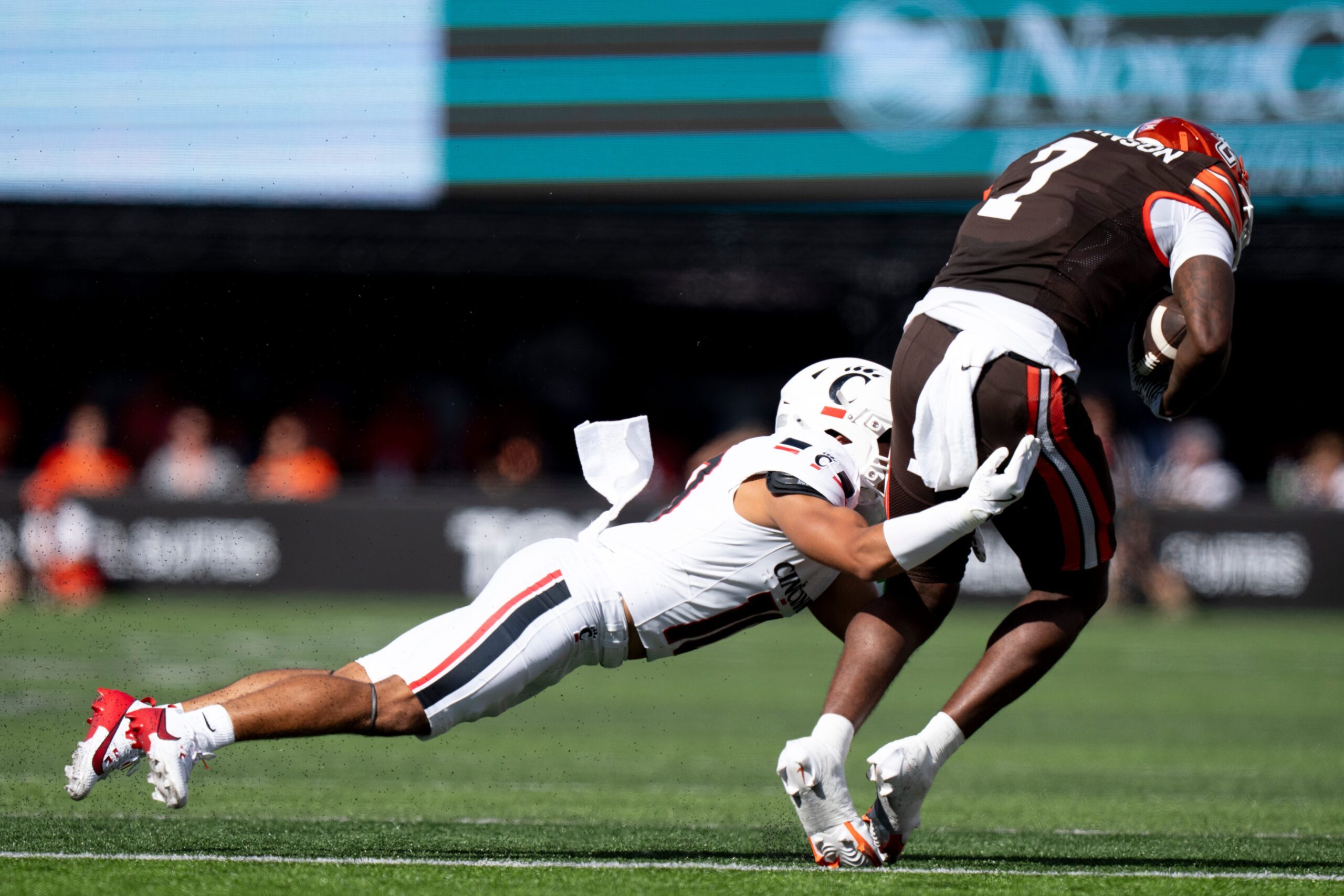 Cincinnati Bearcats safety Tayden Barnes (10) tackles Bowling Green Falcons tight end Jyrin Johnson (7) in the second quarter of the NCAA football game between the Cincinnati Bearcats and Bowling Green Falcons at Nippert Stadium in Cincinnati on Sept. 6, 2025.