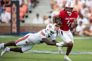 South Alabama Jaguars quarterback Bishop Davenport (4) avoids a tackle from Auburn Tigers defensive end Jared Smith (41) as Auburn Tigers take on South Alabama Jaguars at Jordan-Hare Stadium in Auburn, Ala. on Saturday, Sept. 13, 2025. Auburn Tigers defeated South Alabama Jaguars 31-15.