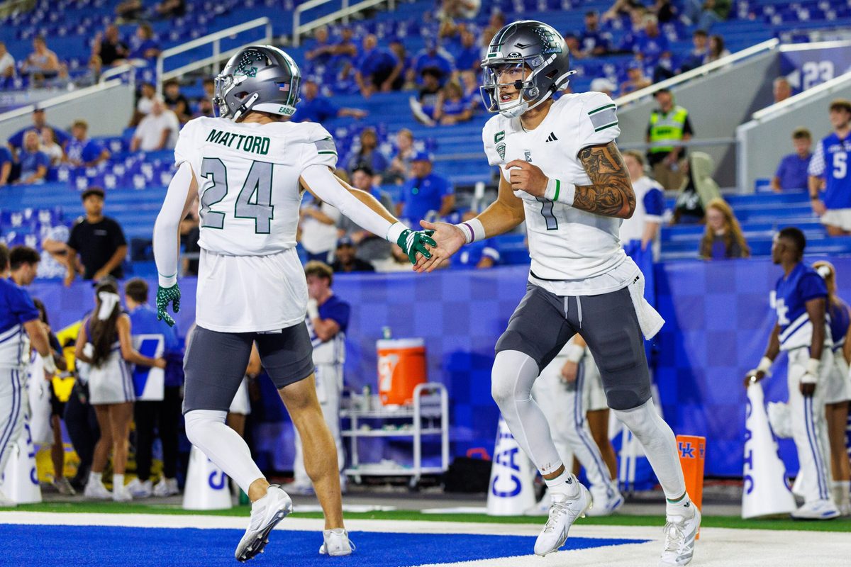 Sep 13, 2025; Lexington, Kentucky, USA; Eastern Michigan Eagles quarterback Noah Kim (1) celebrates with running back Joey Mattord (24) after scoring a touchdown during the fourth quarter against the Kentucky Wildcats at Kroger Field. Mandatory Credit: Jordan Prather-Imagn Images