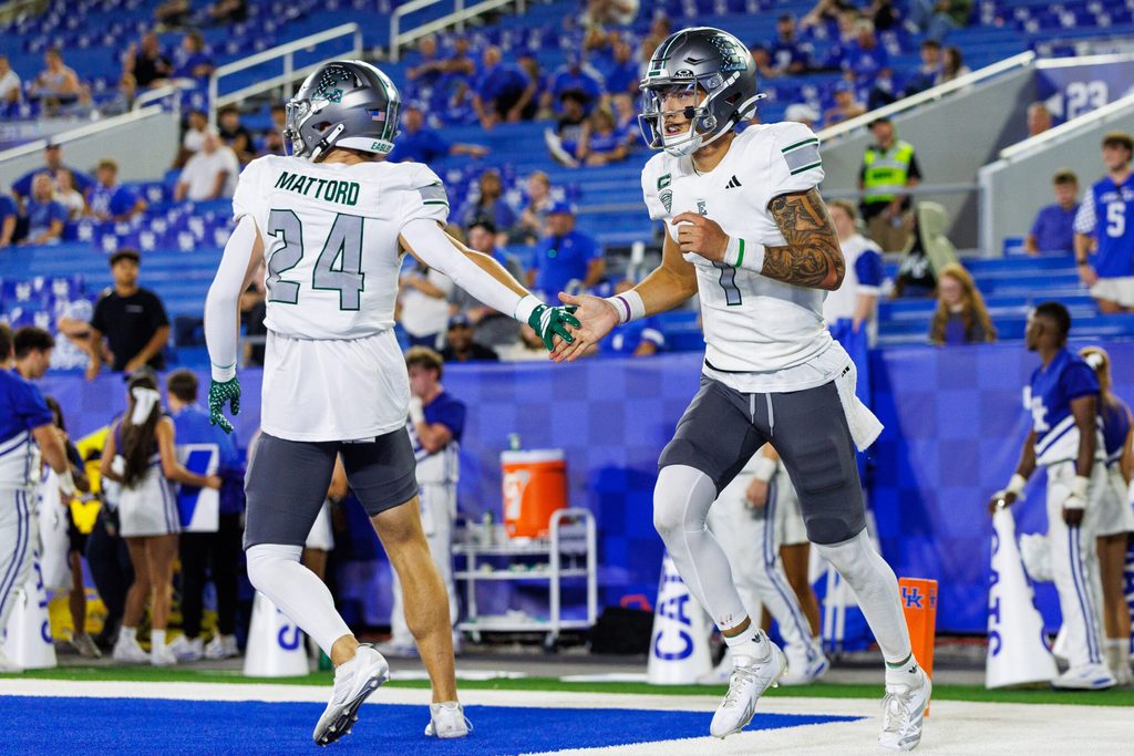 Sep 13, 2025; Lexington, Kentucky, USA; Eastern Michigan Eagles quarterback Noah Kim (1) celebrates with running back Joey Mattord (24) after scoring a touchdown during the fourth quarter against the Kentucky Wildcats at Kroger Field. Mandatory Credit: Jordan Prather-Imagn Images