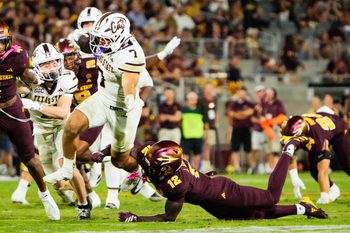 Sep 13, 2025; Tempe, Arizona, USA; Texas State Bobcats running back Lincoln Pare (7) avoids a tackle by Arizona State Sun Devils defensive back Javan Robinson (12) in the third quarter of the game between Arizona State Sun Devils and Texas State Bobcats. Mandatory Credit: Arianna Grainey-Imagn Images