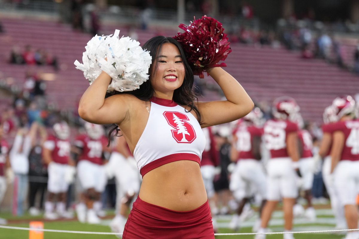 Sep 13, 2025; Stanford, California, USA; A Stanford Cardinal cheerleader performs on the field before the game against the Boston College Eagles at Stanford Stadium. Mandatory Credit: Darren Yamashita-Imagn Images