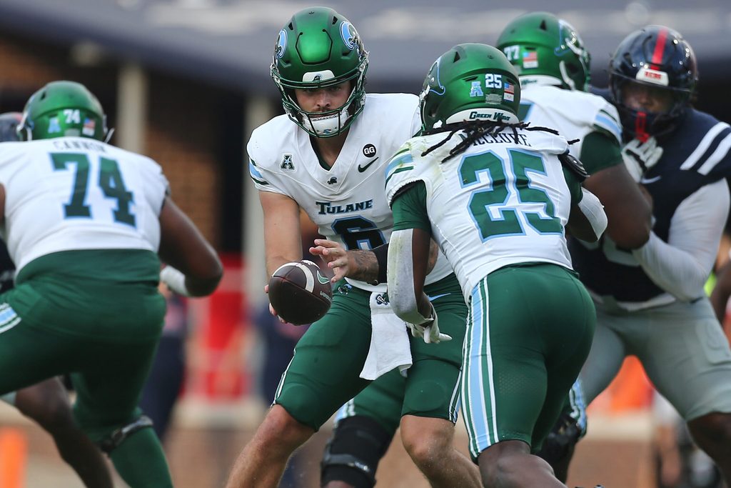 Sep 20, 2025; Oxford, Mississippi, USA; Tulane Green Wave quarterback Brendan Sullivan (6) hands the ball off to running back Jamauri McClure (25) during the fourth quarter against the Mississippi Rebels at Vaught-Hemingway Stadium. Mandatory Credit: Petre Thomas-Imagn Images