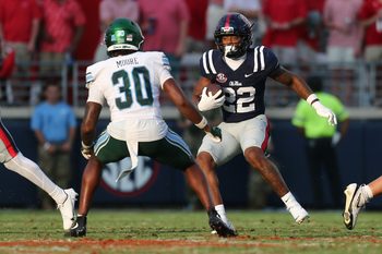 Sep 20, 2025; Oxford, Mississippi, USA; Mississippi Rebels running back Logan Diggs (22) runs the ball during the fourth quarter against the Tulane Green Wave at Vaught-Hemingway Stadium. Mandatory Credit: Petre Thomas-Imagn Images