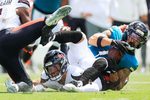 Jacksonville Jaguars wide receiver Parker Washington (11), right, hauls in a reception against Houston Texans linebacker Azzez Al-Shaair (0) and linebacker Henry To'Oto'O (39), bottom, during the first quarter of an NFL football matchup at EverBank Stadium, Sunday, Sept. 21, 2025, in Jacksonville, Fla. The Jaguars defeated the Texans 17-10.