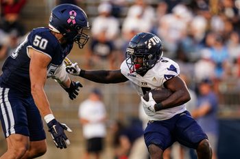 Oct 4, 2025; East Hartford, Connecticut, USA; FIU Panthers running back Kejon Owens (5) runs the ball against UConn Huskies defensive lineman Brandon Kelley (50) in the third quarter at Pratt & Whitney Stadium at Rentschler Field. Mandatory Credit: David Butler II-Imagn Images