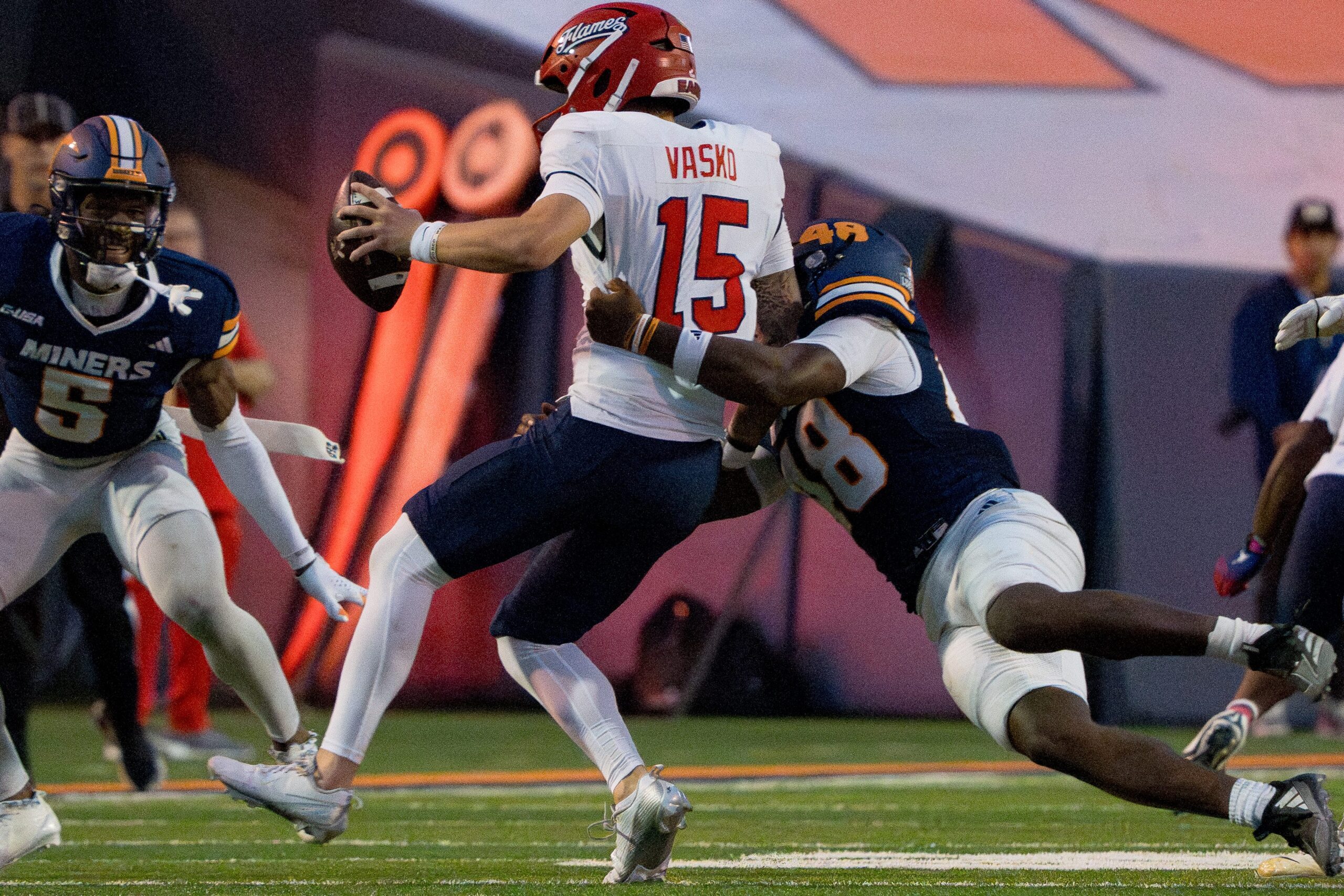 UTEP’s Micah Davey (48) tackles Liberty’s Ethan Vasko (15) during a Conference USA game at the Sun Bowl in El Paso, Texas, on Wednesday, Oct. 8, 2025.