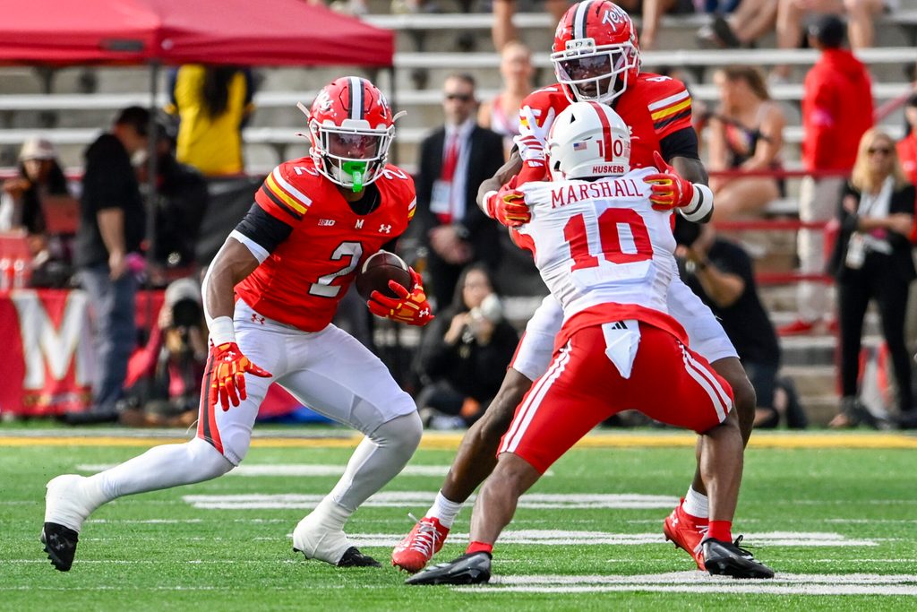 Oct 11, 2025; College Park, Maryland, USA; Maryland Terrapins running back Nolan Ray (2) rushes as wide receiver Shaleak Knotts (4) blocks Nebraska Cornhuskers defensive back Andrew Marshall (10) during the first half at SECU Stadium. Mandatory Credit: Tommy Gilligan-Imagn Images