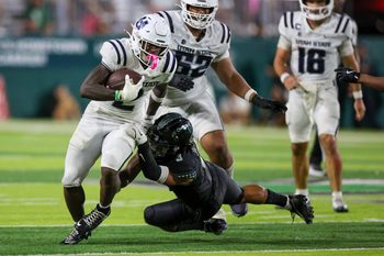 Oct 11, 2025; Honolulu, Hawaii, USA;  Hawaii Rainbow Warriors linebacker Jalen Smith (3) tries to pull down Utah State Aggies running back Miles Davis (2) during the second half at Clarence T.C. Ching Athletics Complex. Mandatory Credit: Marco Garcia-Imagn Images