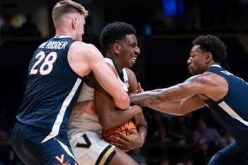 Virginia forward Thijs De Ridder (28) and guard Malik Thomas (1) trap Vanderbilt forward AK Okereke (10) during the second half of their exhibition game at Memorial Gym in Nashville, Tenn., Thursday, Oct. 16, 2025.