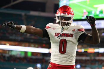 Oct 17, 2025; Miami Gardens, Florida, USA; Louisville Cardinals wide receiver Chris Bell (0) celebrates after scoring a touchdown against the Miami Hurricanes during the first quarter at Hard Rock Stadium. Mandatory Credit: Sam Navarro-Imagn Images