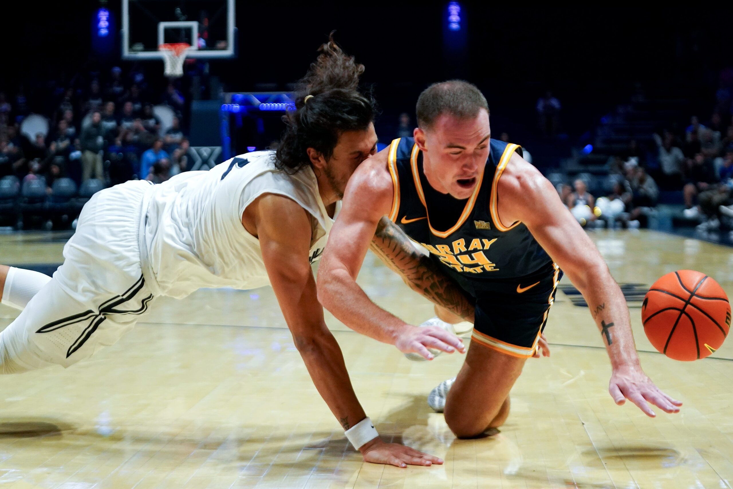 Xavier Musketeers forward Tre Carroll (12) and Murray State Racers guard Brayden Shorter (34) collide in the second half of a NCAA men’s basketball game between the Xavier Musketeers and Murray State Racers, Saturday, Oct. 18, 2025, at Cintas Center in Cincinnati. Racers won 75-70.