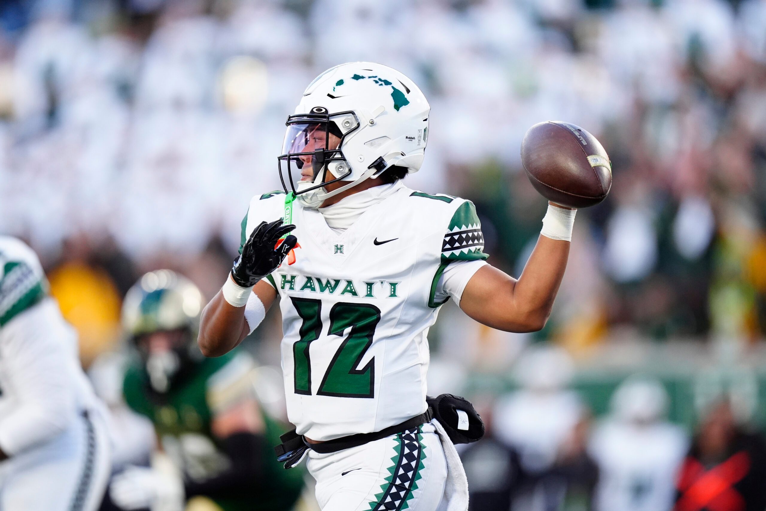 Oct 18, 2025; Fort Collins, Colorado, USA; Hawaii Rainbow Warriors quarterback Micah Alejado (12) prepares to pass against the Colorado State Rams in the first quarter at Sonny Lubick Field at Canvas Stadium. Mandatory Credit: Ron Chenoy-Imagn Images