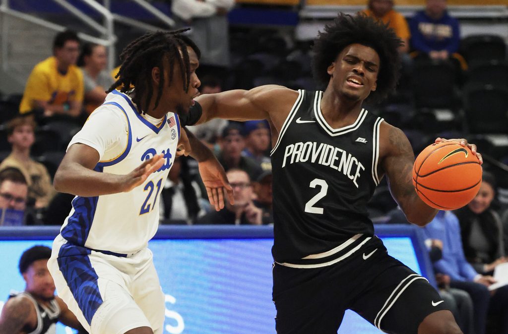 Oct 19, 2025; Pittsburgh, PA, USA; Providence Friars guard Jaylin Sellers (2) controls the ball against Pittsburgh Panthers guard Macari Moore (21) during the first half at the Petersen Events Center. Mandatory Credit: Charles LeClaire-Imagn Images