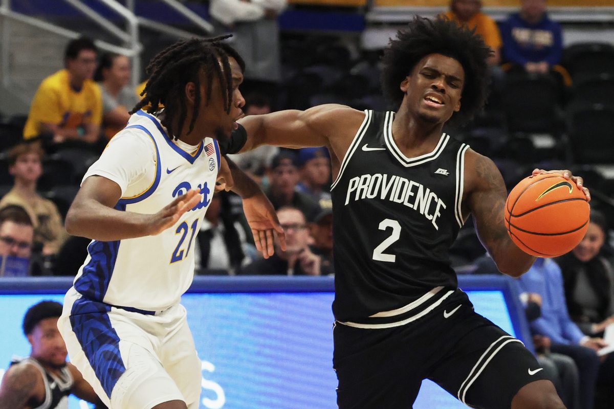 Oct 19, 2025; Pittsburgh, PA, USA; Providence Friars guard Jaylin Sellers (2) controls the ball against Pittsburgh Panthers guard Macari Moore (21) during the first half at the Petersen Events Center. Mandatory Credit: Charles LeClaire-Imagn Images