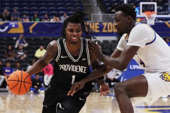 Oct 19, 2025; Pittsburgh, PA, USA;  Providence Friars guard Jason Edwards (1) drives to the basket against Pittsburgh Panthers forward Papa Amadou Kante (4)  during the second half at the Petersen Events Center. Mandatory Credit: Charles LeClaire-Imagn Images