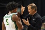 Oregon men's basketball coach, right, talks to Takai Simpkins during the exhibition game against Utah at Matthew Knight Arena Oct. 24, 2025.