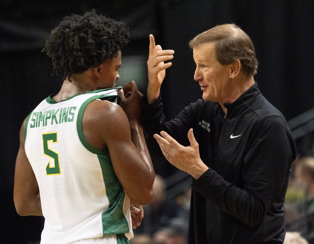 Oregon men's basketball coach, right, talks to Takai Simpkins during the exhibition game against Utah at Matthew Knight Arena Oct. 24, 2025.