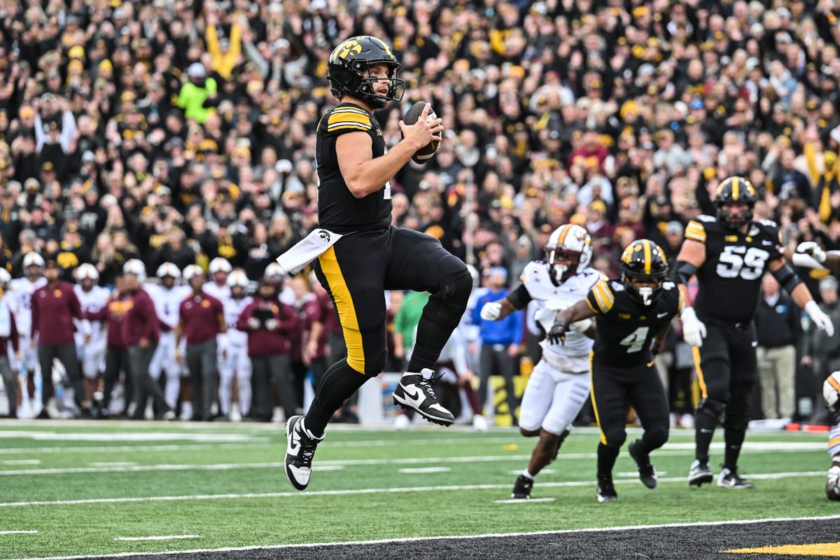 Oct 25, 2025; Iowa City, Iowa, USA; Iowa Hawkeyes quarterback Mark Gronowski (11) runs for a touchdown during the first quarter against the Minnesota Golden Gophers at Kinnick Stadium. Mandatory Credit: Jeffrey Becker-Imagn Images